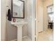 Bright powder room featuring a pedestal sink, neutral paint, and tile flooring at 2871 Cabrillo Terrace St, Henderson, NV 89044