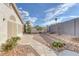 Landscaped backyard with gravel, concrete tiles, and a grey block fence for added privacy at 301 Montcliff Ave, Henderson, NV 89074