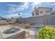 Spacious backyard with a concrete patio, gravel landscaping, a metal fence, and desert foliage at 301 Montcliff Ave, Henderson, NV 89074
