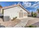 Low-maintenance backyard featuring gravel landscaping, an air conditioning unit, and a concrete patio at 301 Montcliff Ave, Henderson, NV 89074