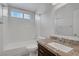 Well-lit bathroom featuring a shower-tub combination and vanity with granite counters at 301 Montcliff Ave, Henderson, NV 89074