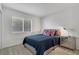 The cozy bedroom includes a window for natural light, a nightstand, and a comfortable bed at 301 Montcliff Ave, Henderson, NV 89074