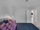 The bedroom has soft, decorative pillows and a nightstand next to the door for convenience at 301 Montcliff Ave, Henderson, NV 89074