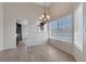 Bright dining room featuring a modern chandelier and large window for natural light at 301 Montcliff Ave, Henderson, NV 89074