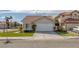 Charming single-story home featuring a well-manicured lawn, tile roof and a two-car garage at 301 Montcliff Ave, Henderson, NV 89074