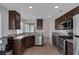Modern kitchen featuring stainless steel appliances, granite countertops, and breakfast bar at 301 Montcliff Ave, Henderson, NV 89074