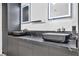 Elegant bathroom featuring dual sinks with marble countertops and modern fixtures at 3130 Appleblossom Cir, Las Vegas, NV 89117