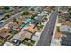An aerial view of a single story home with a yard and a quiet street in a Gathering neighborhood at 325 Greenfield Ln, Las Vegas, NV 89107