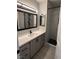 Bathroom featuring gray vanity with white counters and modern glass shower at 325 Greenfield Ln, Las Vegas, NV 89107
