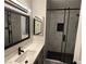 This bathroom features a vanity with stone countertop and a tile shower with glass door at 325 Greenfield Ln, Las Vegas, NV 89107