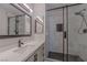 The renovated bathroom has a new sink, hardware and a shower with gorgeous tiling at 325 Greenfield Ln, Las Vegas, NV 89107
