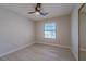 Bright bedroom with gray flooring, modern ceiling fan, and a large mirrored closet at 325 Greenfield Ln, Las Vegas, NV 89107