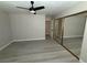 Bright bedroom with wide closet, light gray walls, ceiling fan and wood look flooring at 325 Greenfield Ln, Las Vegas, NV 89107