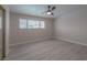 Neutral bedroom features gray flooring and modern ceiling fan at 325 Greenfield Ln, Las Vegas, NV 89107