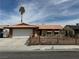 Charming single-story home featuring a well-maintained front yard and a classic red-tiled roof at 325 Greenfield Ln, Las Vegas, NV 89107