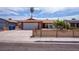 Charming single-story home featuring a quaint fenced yard and two-car garage at 325 Greenfield Ln, Las Vegas, NV 89107