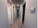 Hallway with gray wood floors and multiple doors at 325 Greenfield Ln, Las Vegas, NV 89107