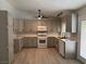 Spacious kitchen with ample counter space, modern appliances, and a cozy ceiling fan at 325 Greenfield Ln, Las Vegas, NV 89107