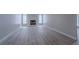 Bright living room with a fireplace, neutral paint, and sleek gray flooring at 325 Greenfield Ln, Las Vegas, NV 89107