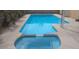 Inviting in-ground pool and attached spa with surrounding concrete patio for outdoor enjoyment at 325 Greenfield Ln, Las Vegas, NV 89107