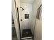 Modern shower featuring white marble wall tiles, black hardware and black hexagon floor tiles at 325 Greenfield Ln, Las Vegas, NV 89107