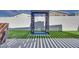 A backyard featuring a modern water feature, well-maintained artificial grass, and privacy fencing at 3264 Monte Luna Ave, Henderson, NV 89044