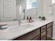 Modern bathroom featuring a double sink vanity with white countertop and dark wood cabinets at 3264 Monte Luna Ave, Henderson, NV 89044