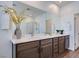 Bathroom vanity with dual sinks, a large mirror, and stylish cabinetry at 3264 Monte Luna Ave, Henderson, NV 89044