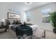 Well-lit staged bedroom with large windows and neutral tones for a relaxing atmosphere at 3264 Monte Luna Ave, Henderson, NV 89044