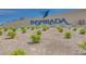 Entrance to Inspirada community featuring a sign with the community name and a hummingbird logo against a desert landscape at 3264 Monte Luna Ave, Henderson, NV 89044