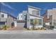 Modern two-story home with gray and white color scheme, landscaped front yard, and attached two-car garage at 3264 Monte Luna Ave, Henderson, NV 89044