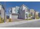 Modern two-story home with gray and white color scheme, landscaped front yard, and attached two-car garage at 3264 Monte Luna Ave, Henderson, NV 89044