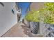 Landscaped side path with large potted plants leading to the backyard of the modern home at 3264 Monte Luna Ave, Henderson, NV 89044