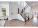 Open foyer with hardwood floors, staircase, and white walls for a bright, modern entry at 3264 Monte Luna Ave, Henderson, NV 89044