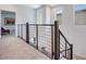 Upstairs hallway with carpet, wood railing, and horizontal metal balusters at 3264 Monte Luna Ave, Henderson, NV 89044