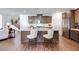 Modern kitchen with island, barstool seating, stainless appliances, and wood cabinets at 3264 Monte Luna Ave, Henderson, NV 89044