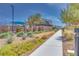 A beautiful landscaped walkway leads to community amenities with modern homes in the background at 3264 Monte Luna Ave, Henderson, NV 89044