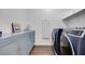 Well-organized laundry room with a washer, dryer, cabinets, and storage shelves at 3264 Monte Luna Ave, Henderson, NV 89044