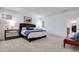 Bright main bedroom featuring a large bed, carpet, and ensuite bathroom entrance at 3264 Monte Luna Ave, Henderson, NV 89044