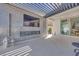 A well-appointed outdoor living space with a fireplace, television, covered pergola, and seamless indoor-outdoor flow at 3264 Monte Luna Ave, Henderson, NV 89044