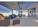 An inviting outdoor living area with modern pergola, comfortable seating, fireplace, and television for entertainment at 3264 Monte Luna Ave, Henderson, NV 89044