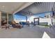 Inviting outdoor living space with comfortable seating, pergola, and elegant tile flooring at 3264 Monte Luna Ave, Henderson, NV 89044