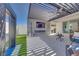 Outdoor living space features an outdoor fireplace, television, water feature, pergola, and comfortable lounge area at 3264 Monte Luna Ave, Henderson, NV 89044