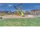 The bright, modern playground features slides and climbing frames alongside a grassy picnic area at 3264 Monte Luna Ave, Henderson, NV 89044