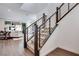 Staircase with carpeted steps, wood handrail, and metal balusters with lots of natural light at 3264 Monte Luna Ave, Henderson, NV 89044