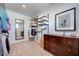 Bright walk-in closet featuring a mirror, custom shelving, and stylish storage solutions at 3264 Monte Luna Ave, Henderson, NV 89044