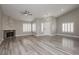 Spacious living room with modern ceiling fan, new flooring, fireplace and plantation shutters at 3607 Bixbee Ct, Las Vegas, NV 89129