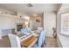 Bright dining room with a fireplace, a large window, and a wooden dining table at 3700 Hedge Grove Dr, North Las Vegas, NV 89032