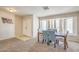 Inviting dining room featuring a bay window, carpet floors, and a modern table set at 3700 Hedge Grove Dr, North Las Vegas, NV 89032