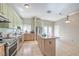 Bright kitchen featuring an island, stainless steel appliances, and tile floors at 3700 Hedge Grove Dr, North Las Vegas, NV 89032